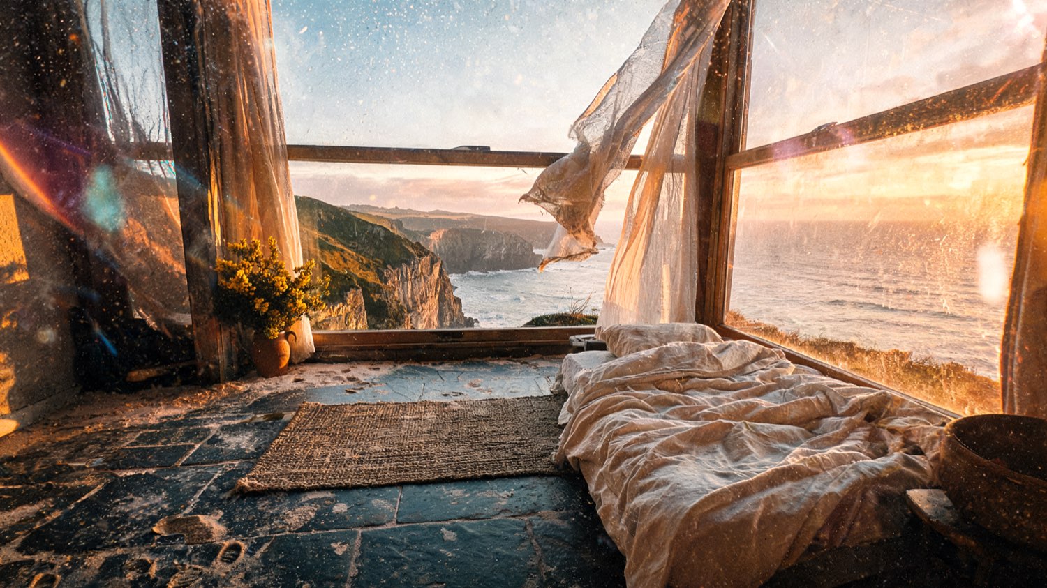 Suite interior with tall windows to the sea